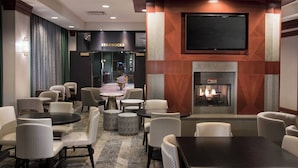 A hotel lobby with a Starbucks, a fireplace, and various seating arrangements. - Residence Inn by Marriott Memphis Downtown (Memphis)