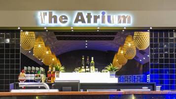 Zona de bar con un cartel que dice 'The Atrium'.
