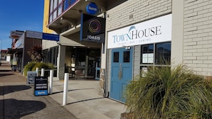 A building with a sign for 'TownHouse' offering a lounge, bar, and gaming.