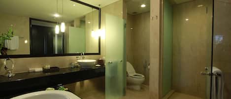 A modern bathroom with a bathtub, sink, and toilet.