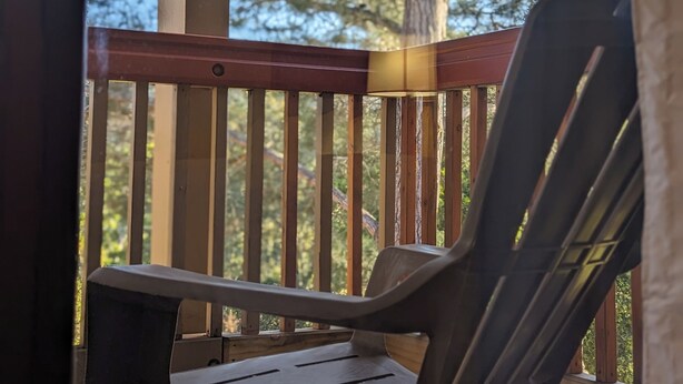A wooden deck with a chair and a railing. - Comfort Inn Monterey Peninsula Airport (Monterey)