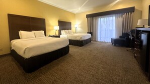 A hotel room with two beds, a desk, a chair, and a large window with curtains. - Comfort Inn Monterey Peninsula Airport (Monterey)