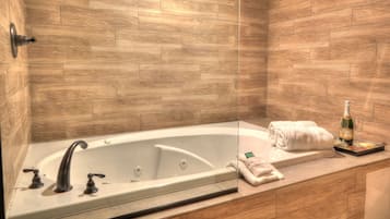 A modern bathroom with a freestanding bathtub, a glass shower enclosure, and a wooden wall.