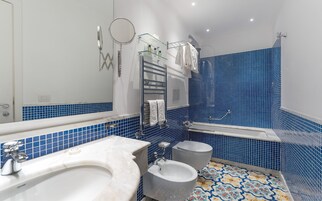 Ein Badezimmer mit einem weißen Waschbecken, einem Bidet und einer Badewanne.