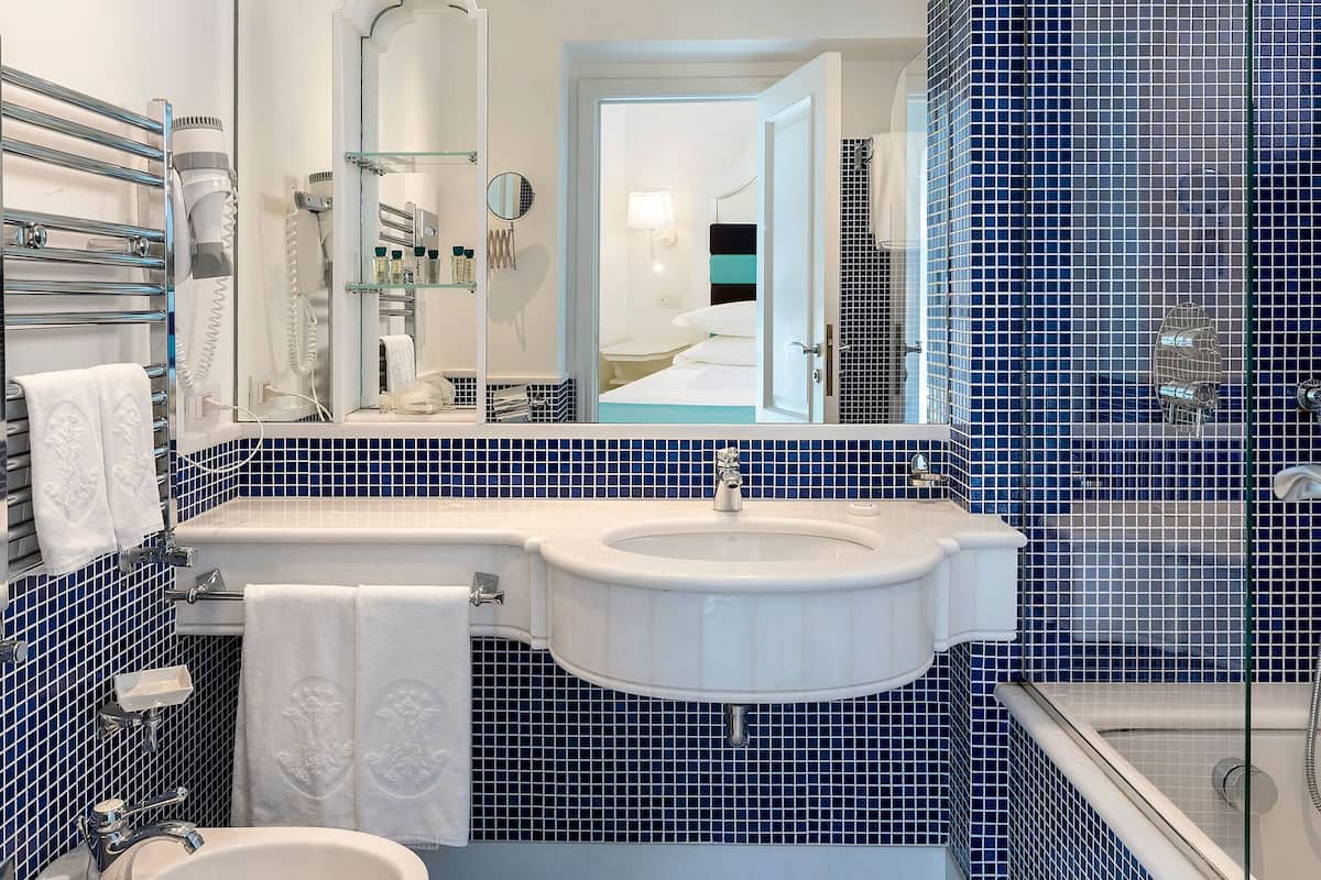 premier room, patio, poolside | bathroom | designer toiletries, hair dryer, slippers, bidet