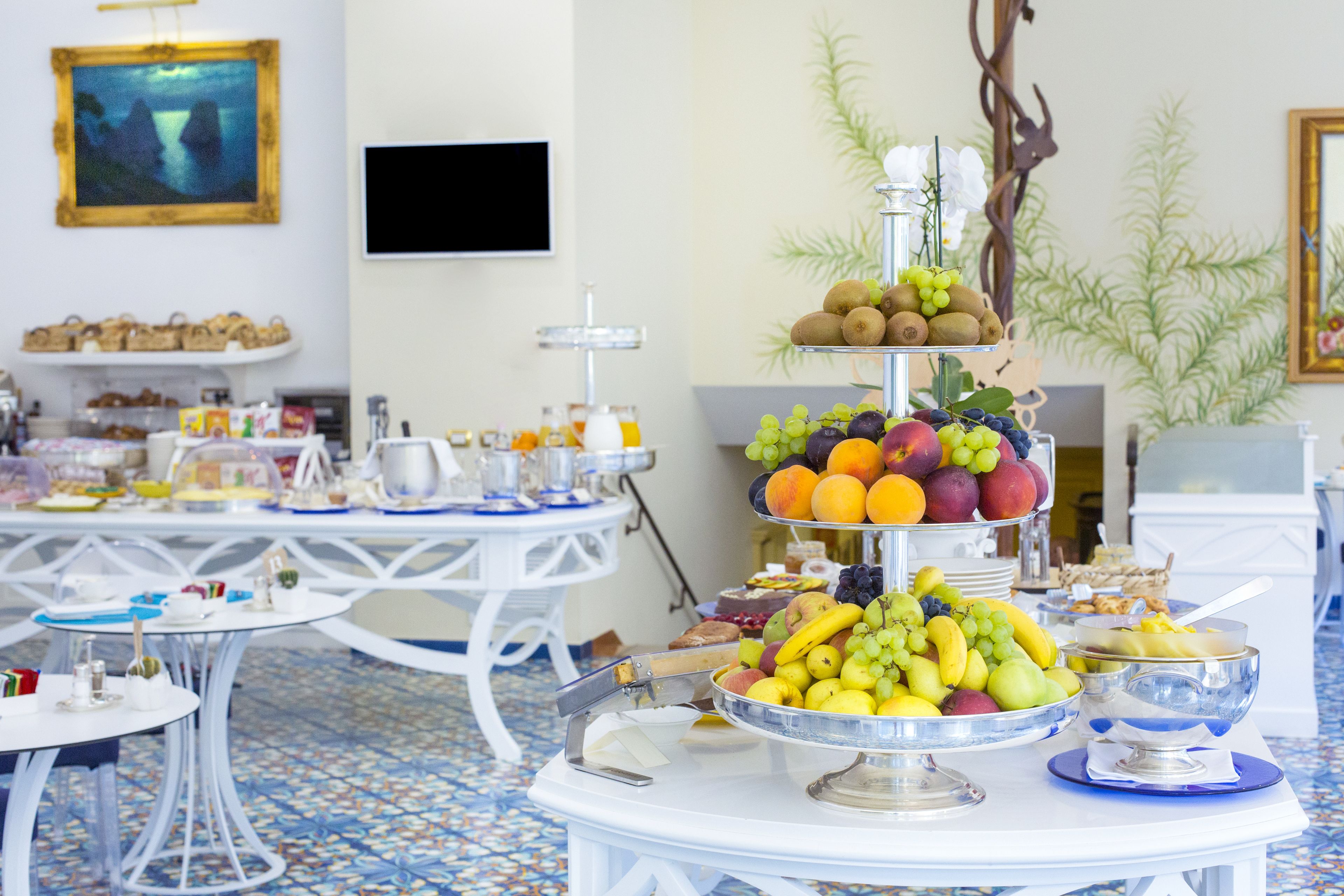 A buffet table with various fruits and pastries.