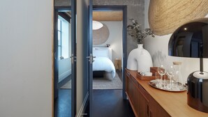 A modern hotel room with a bed, bedside table, and a large mirror. - One Hundred Shoreditch (London)