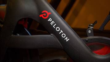A close-up of a bicycle frame with the brand name "PELOTON" visible.