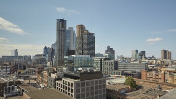 A cityscape with modern high-rise buildings, a mix of architectural styles, and a clear sky.