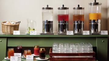 A beverage station with various drink dispensers and containers.