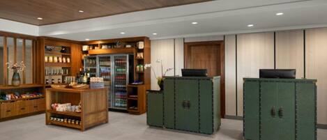 A lobby with wooden cabinets, a reception desk, and a beverage cooler.