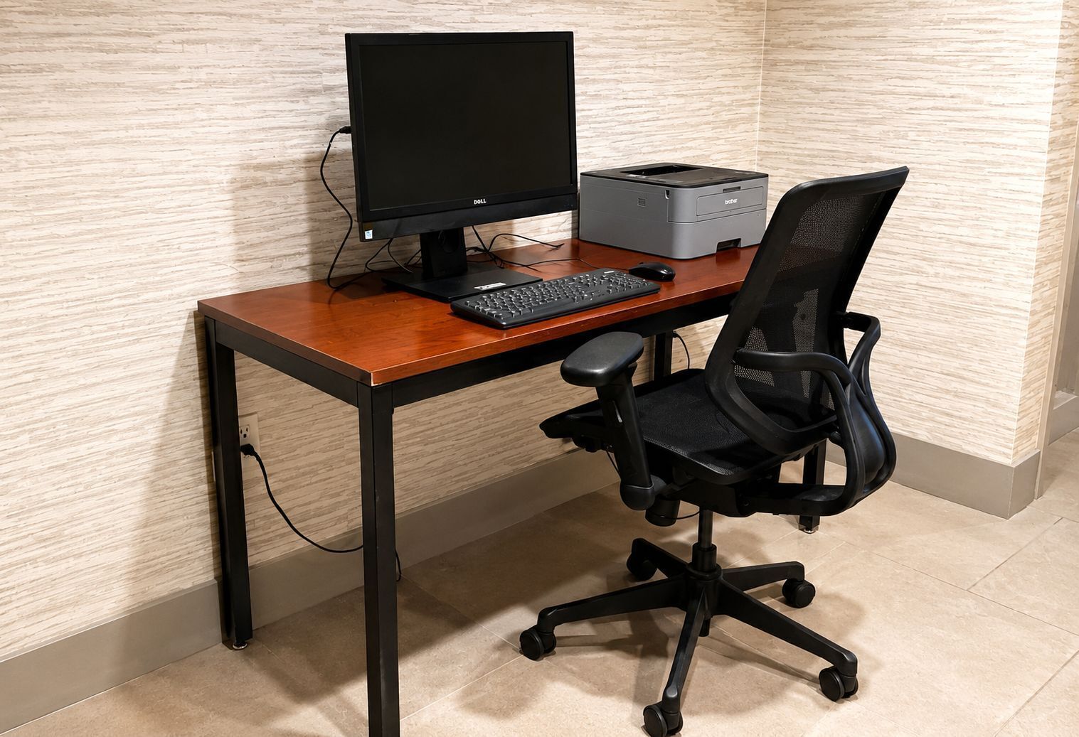 A wooden desk with a computer, keyboard, and printer.