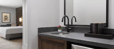 A modern bathroom with a built-in sink, a mirror, and a dishwasher.