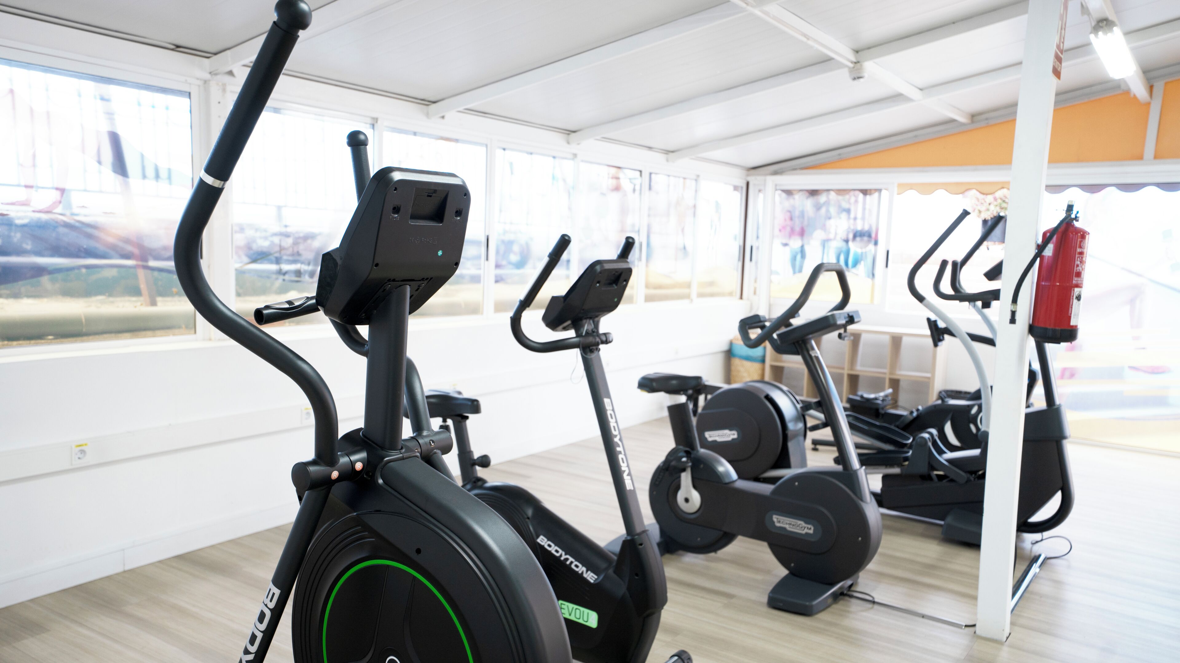 An indoor gym with stationary bikes and exercise equipment.