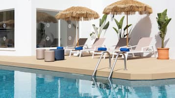 Seasonal outdoor pool, open 9:00 AM to 8:00 PM, pool umbrellas