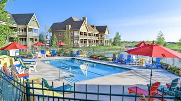 Relax by the resort's large pool surrounded by lounge chairs and umbrellas.