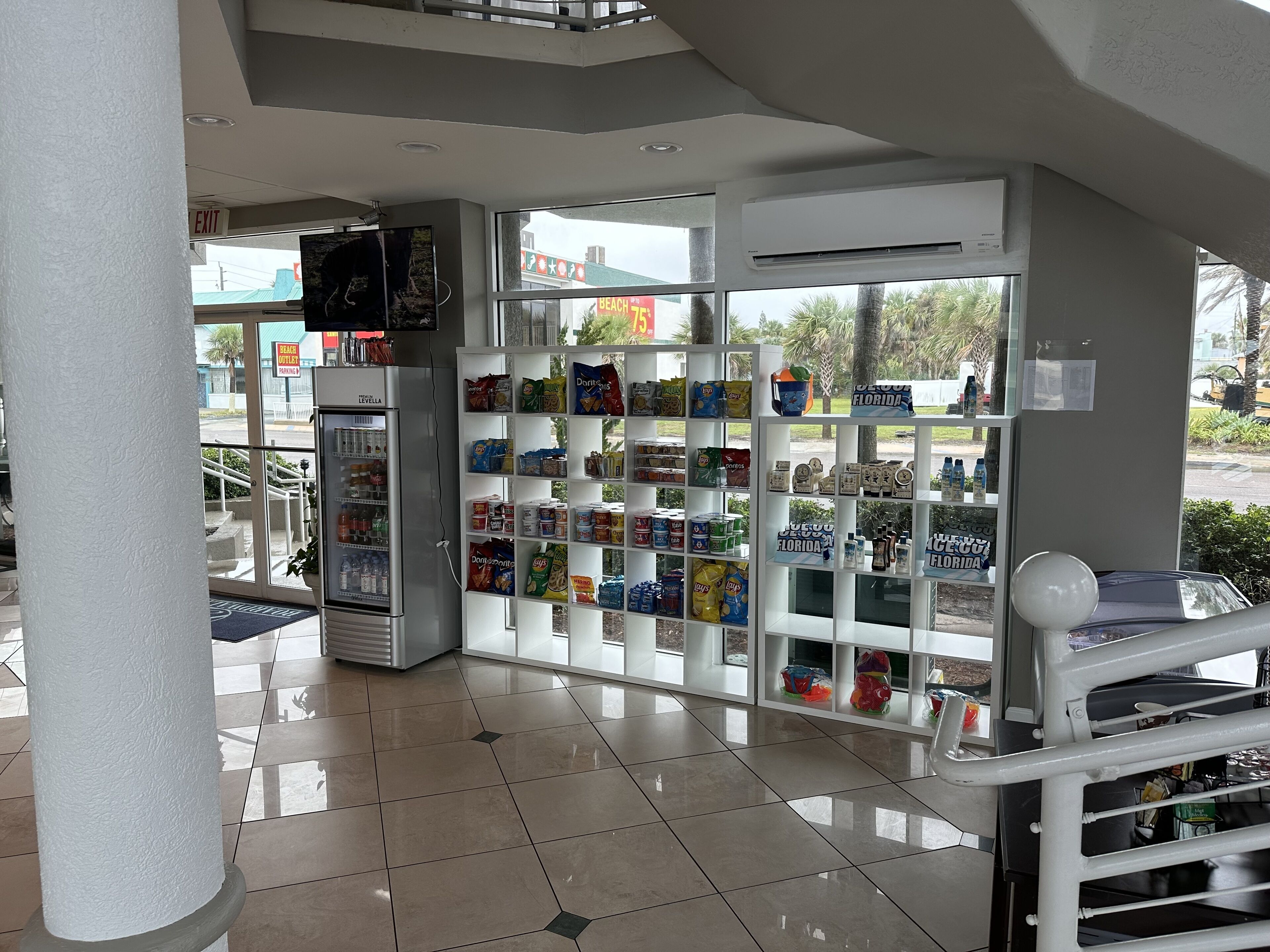 A clean, well-lit interior with a vending machine stocked with snacks and a refrigerator.