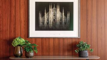 A framed architectural drawing of a Gothic-style building on a wooden wall.