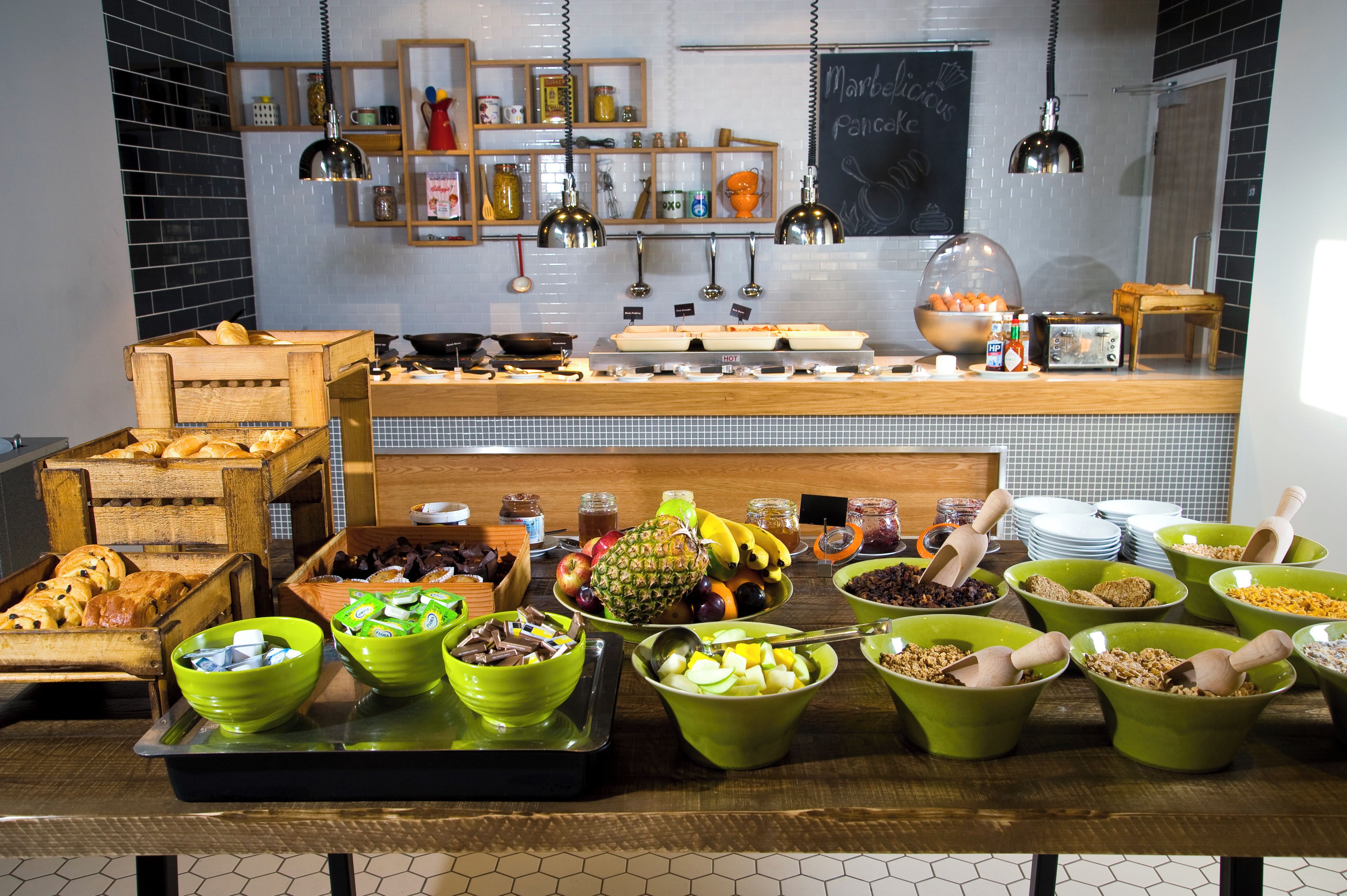 A buffet setup with various food items and utensils.