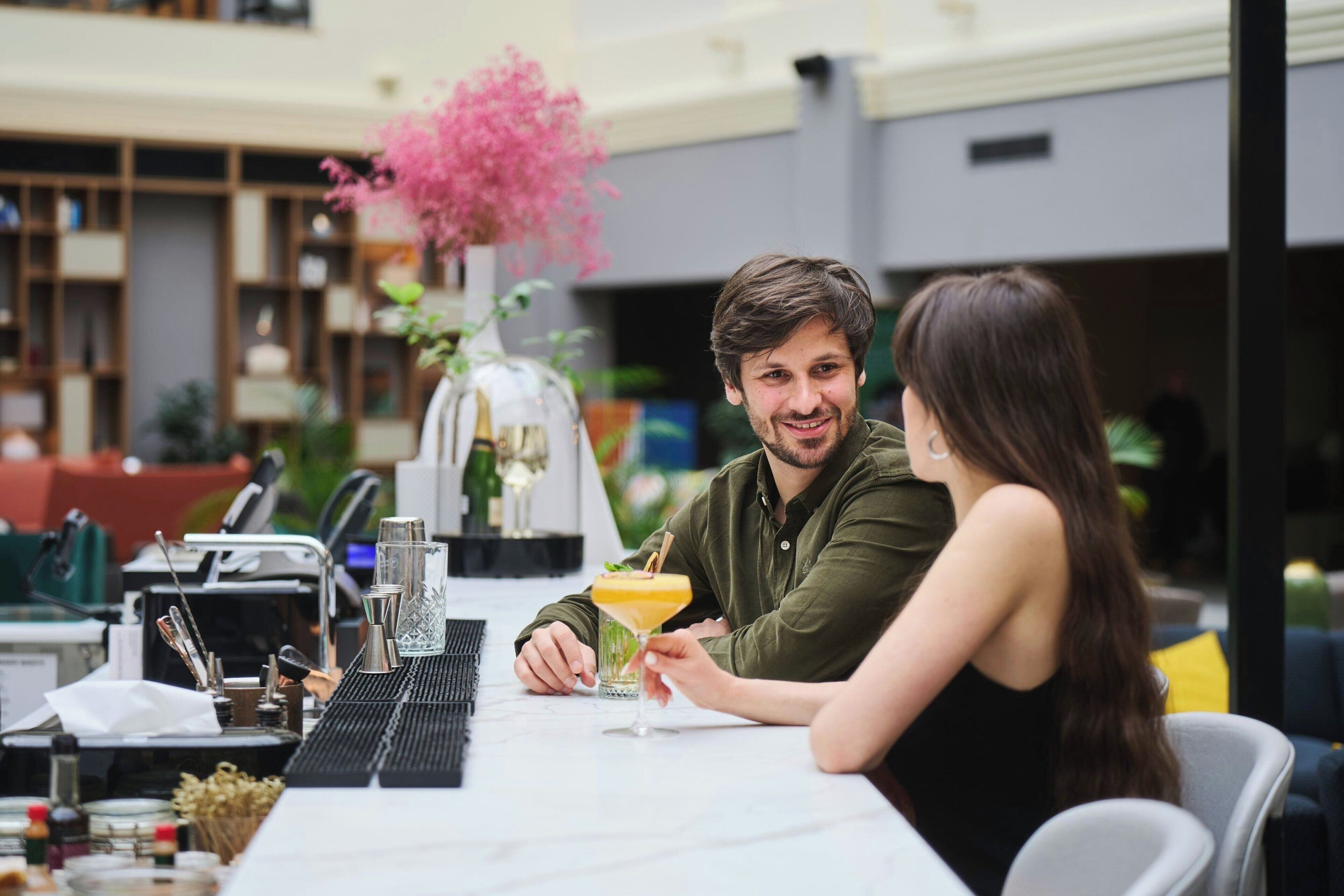 A bar area with a bar counter, a cocktail glass, and a potted plant.