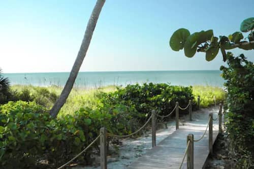 On the beach, white sand, beach cabanas, sun-loungers