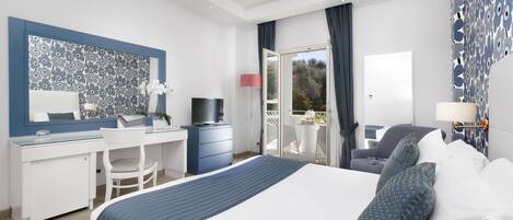 A modern hotel room with a large bed, a desk, a chair, a TV, and a balcony with a view.