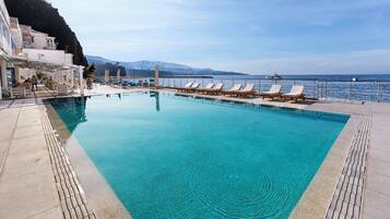 Outdoor pool, open 10:00 AM to 6:00 PM, pool umbrellas, pool loungers