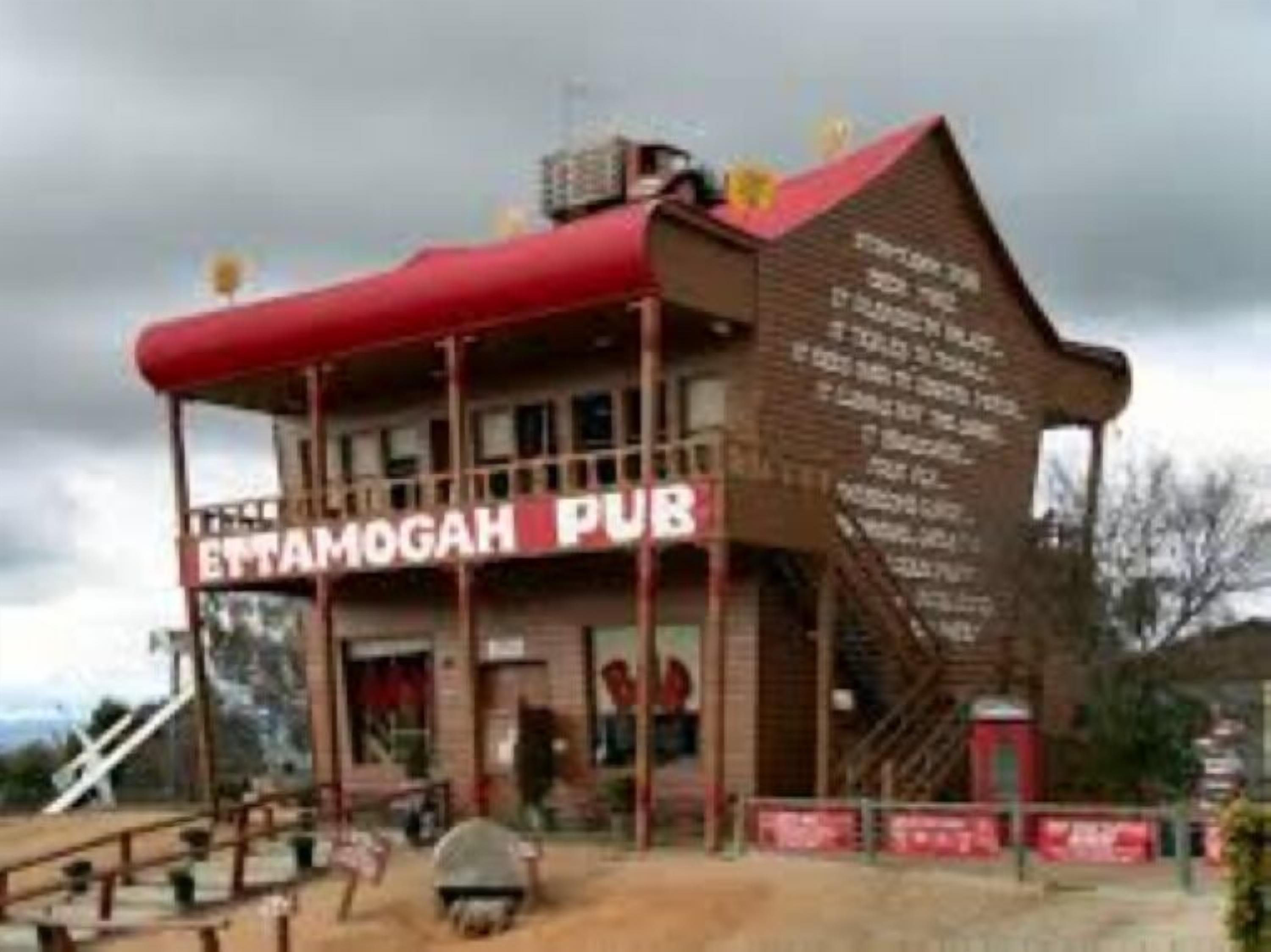 A building with a sign reading "Ettamogah Pub" and a staircase leading to the entrance.