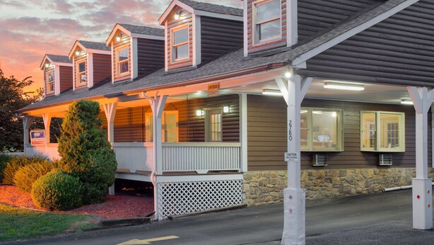 A two-story building with a porch and multiple windows, likely a lodging establishment. - Super 8 by Wyndham Christiansburg (Christiansburg)