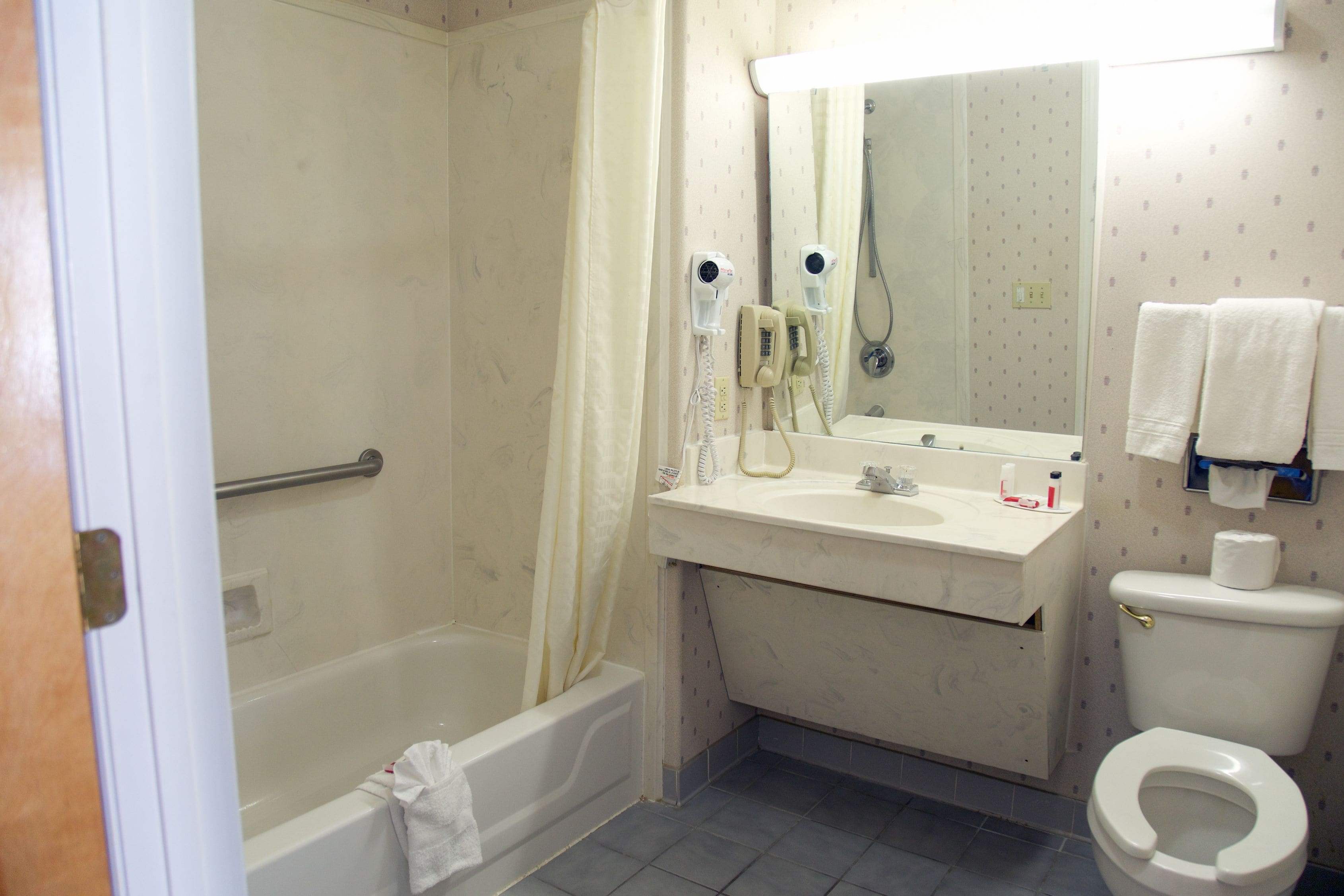 A bathroom with a bathtub, a sink, a toilet, and a shower.