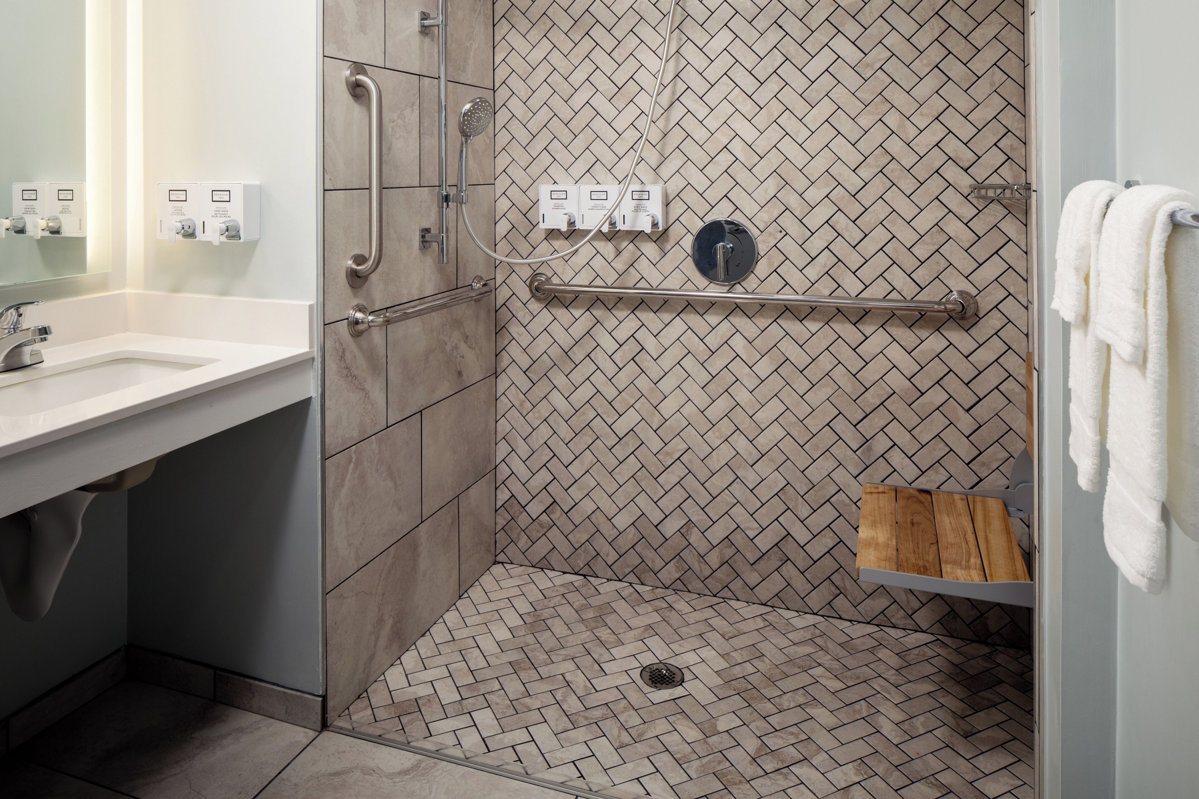 shower, designer toiletries, hair dryer, towels