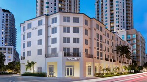 A Courtyard by Marriott hotel with a modern design, multiple floors, and a prominent entrance.