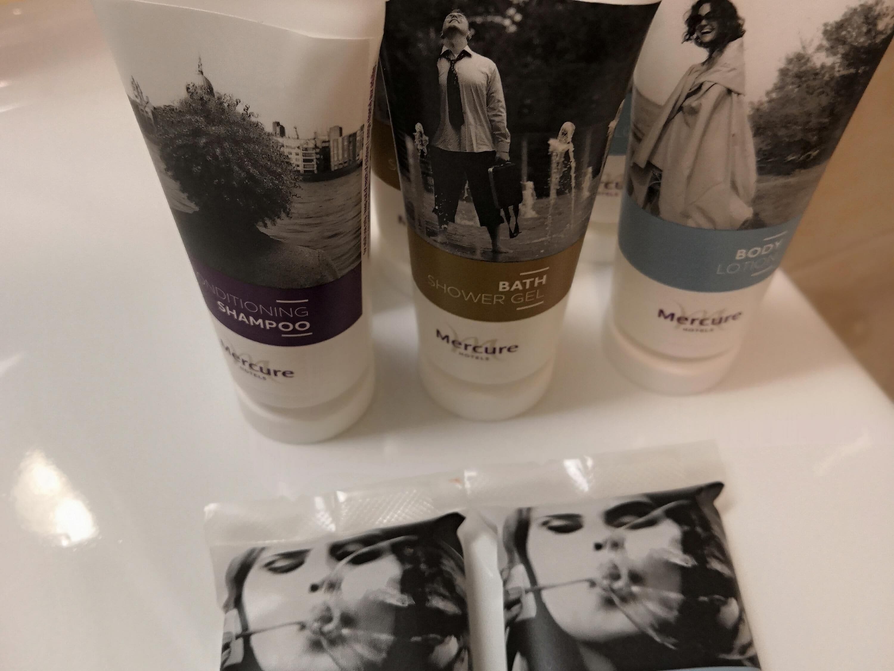 Three bottles of Mercure body care products on a white surface.