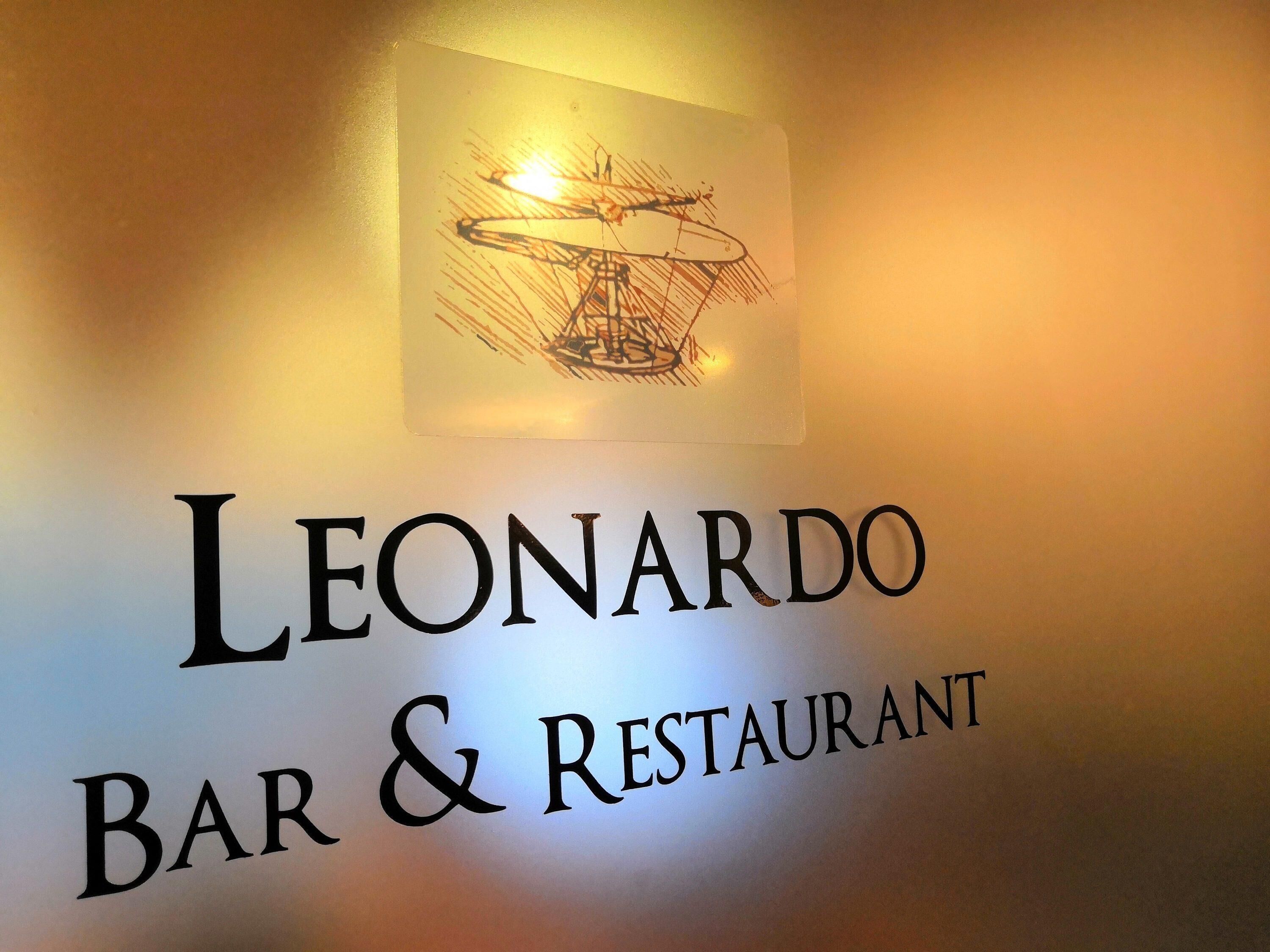 A sign for 'Leonardo Bar & Restaurant' with a logo above the text.