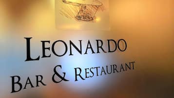 A sign for 'Leonardo Bar & Restaurant' with a logo above the text.