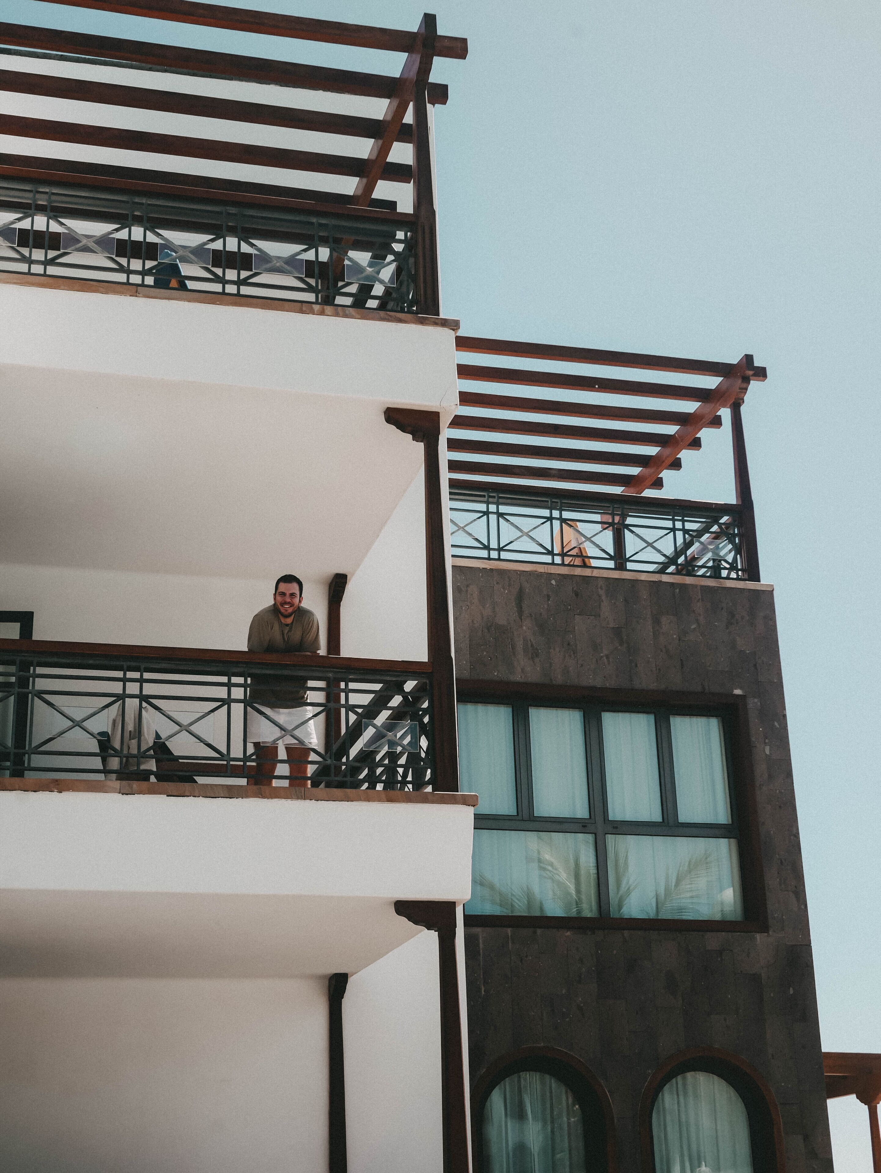 A multi-story building with balconies and a modern architectural design.