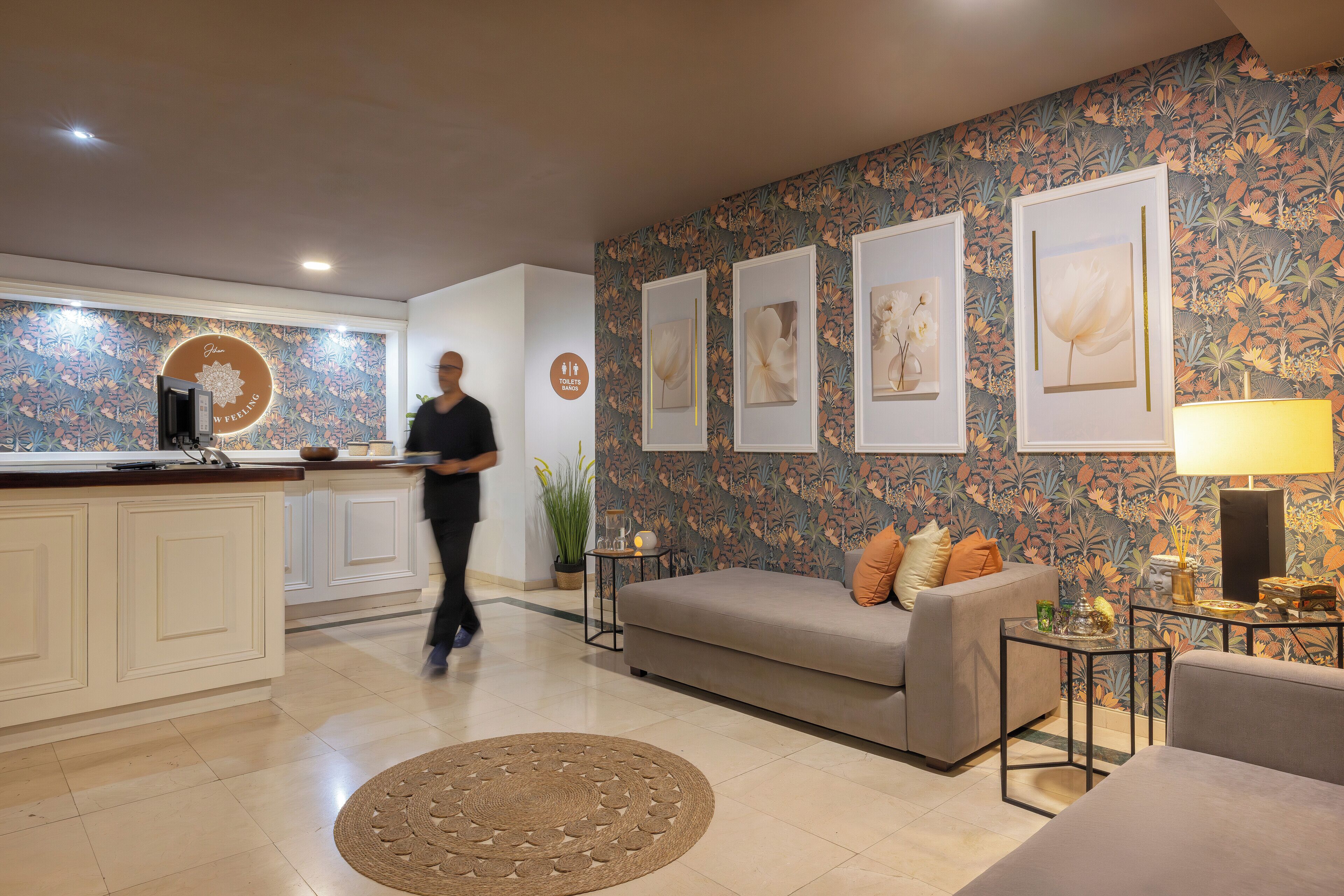 A modern living area with a sofa, a coffee table, and framed artwork on the wall.