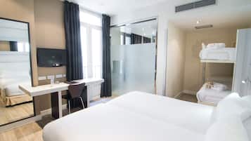 Vierpersoonskamer | Een minibar, een kluis op de kamer, een bureau, verduisterende gordijnen