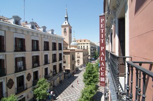 A historic square with a prominent Petit Palais building, featuring a central fountain and surrounding classical architecture.