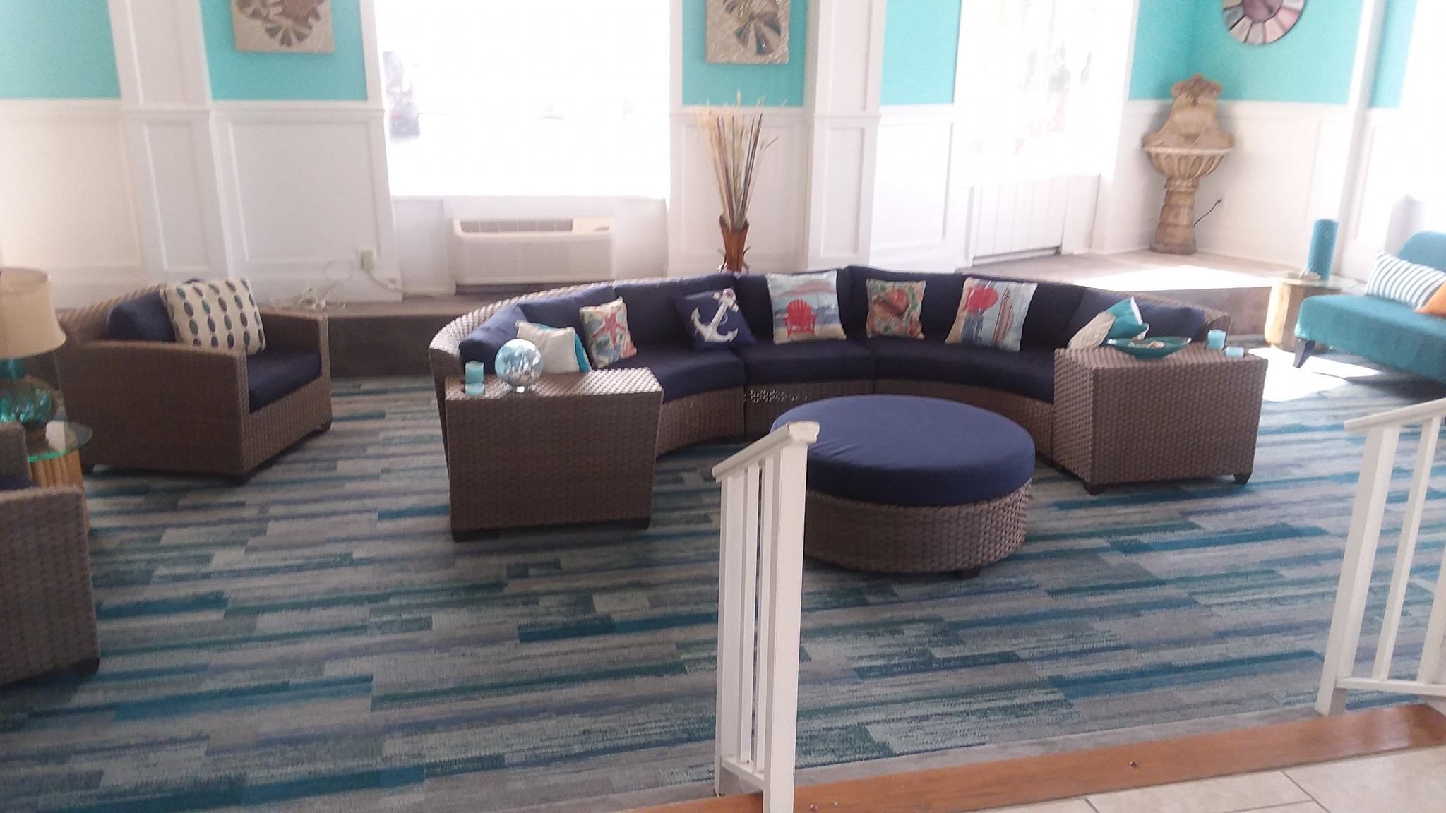 A living room with a curved sectional sofa, two armchairs, and a small coffee table.