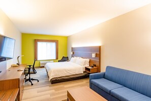 A hotel room with a bed, a desk, a chair, a sofa, a TV, and a window with blinds. - Holiday Inn Express Hereford by IHG (Hereford)