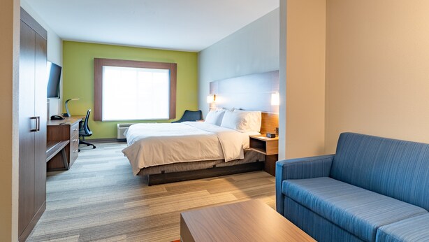 A hotel room with a bed, a desk, a chair, a sofa, and a television. - Holiday Inn Express Hereford by IHG (Hereford)