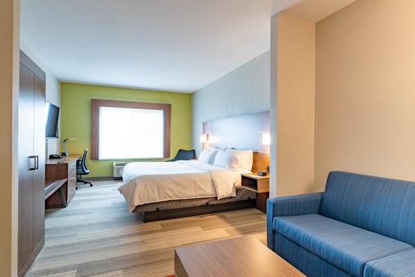 A hotel room with a bed, a desk, a chair, a sofa, and a television. - Holiday Inn Express Hereford by IHG (Hereford)