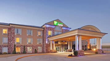 A Holiday Inn Express hotel with a brick facade, large windows, and a covered entrance area.