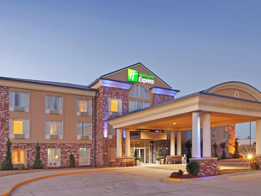 A Holiday Inn Express hotel with a brick facade, large windows, and a covered entrance area.