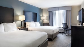 A hotel room with two beds, a desk, a chair, a TV, and a window with curtains. - Holiday Inn Express Hotel and Suites Arcadia by IHG (Arcadia)