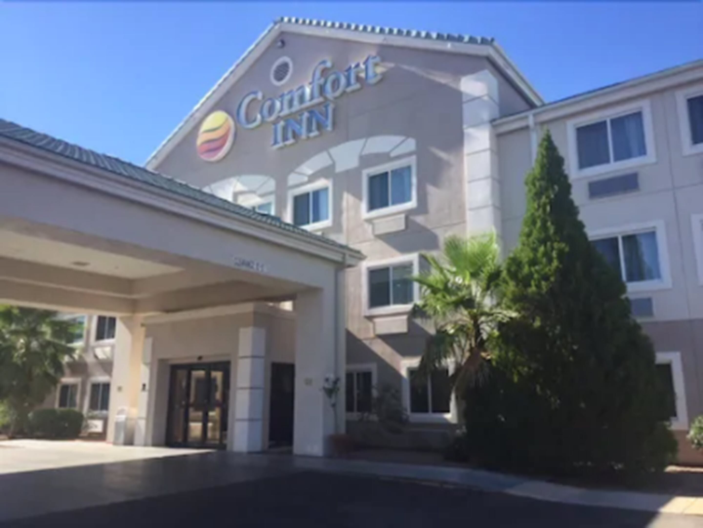 A Comfort Inn hotel with a large sign, a covered entrance, and a well-maintained exterior.