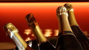 A bucket containing several bottles of champagne with labels visible.