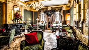 A luxurious interior with ornate furniture, a grand chandelier, and a fireplace. - Hotel de Castillion (Bruges)