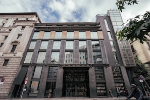 A modern building with large windows and a prominent entrance.